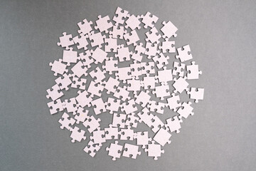 Top view of many puzzle pieces throughout the frame. Background image of scattered colorful puzzle...