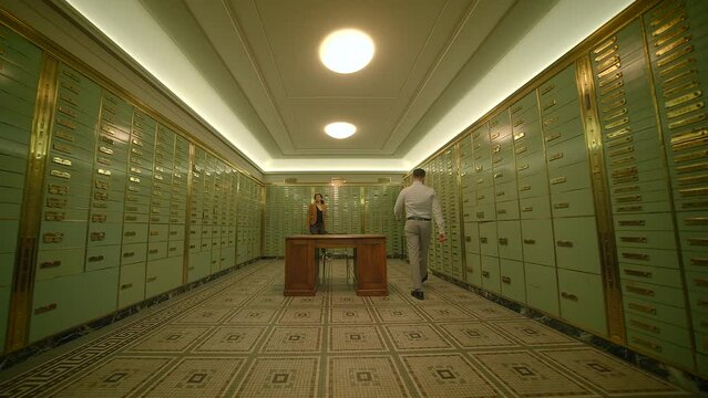 A secure vault room within a bank safely manages safety deposit boxes for storing valuable items