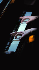 Close-up of the pianist's hand playing the piano skilfully, creating an intimate atmosphere. The...