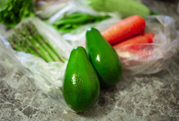 Asparagus officinalis bundle. Ripe green peas. Whole avocado. Orange carrots. Organic raw grocery vegetables.