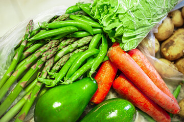 Asparagus officinalis bundle. Ripe green peas. Whole avocado. Orange carrots. Organic raw grocery vegetables.