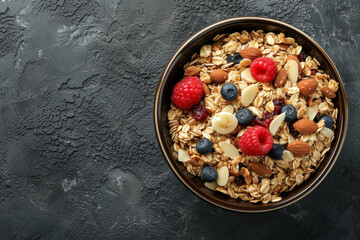 Appetizing muesli in a plate on the table. View from above. Copy space, space for your text.