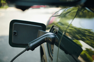 Electric vehicle with plugged charging cable