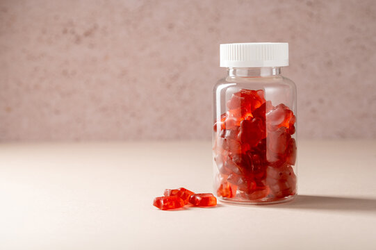 Fruit jelly gummy vitamins in a jar, food supplement.