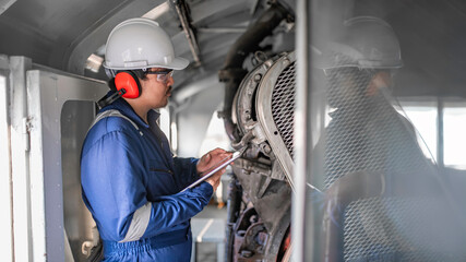 Engine engineer inspecting large machines in factory,Railway engine maintenance technician,engine repair mechanical manager