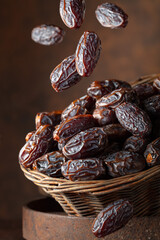 Dates in a old basket on a brown background.