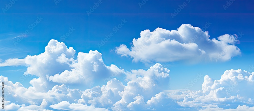 Poster beautiful white fluffy clouds contrasted against a deep blue sky create a serene copy space image.