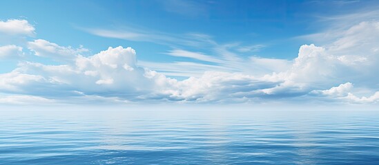 Seascape background featuring a beautiful blue sea under a cloud-filled sky with copy space image.