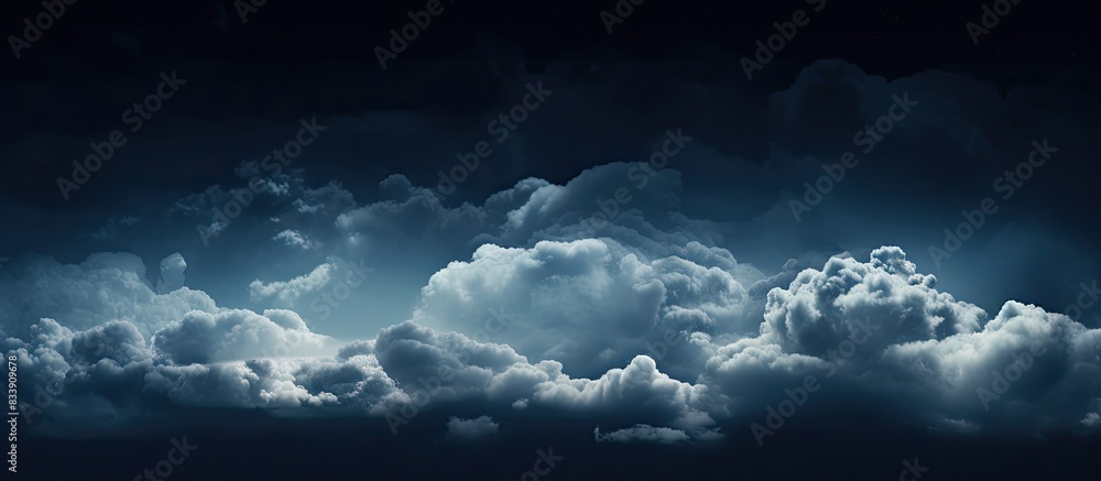 Poster Clouds floating above a dark background with copy space image available.
