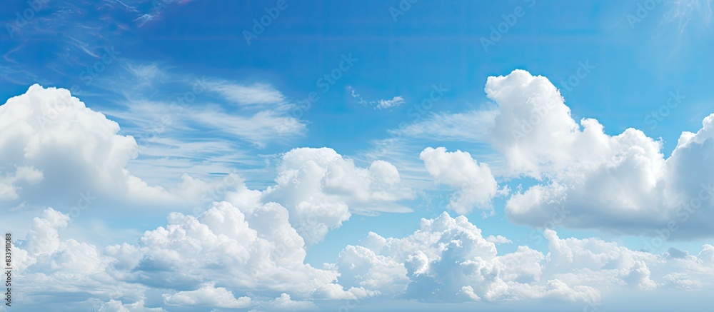 Poster blue sky with fluffy clouds provides a serene copy space image.