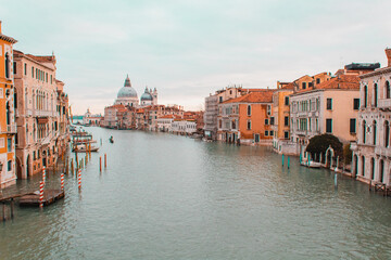 A small boat in a body of water with Grand Canal in the background