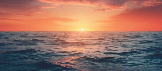 Fototapeta premium Sun setting over the ocean with copy space image.