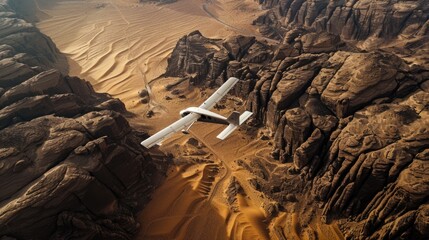 A small plane flies over a vast desert area with sandy dunes and rocky formations - Powered by Adobe