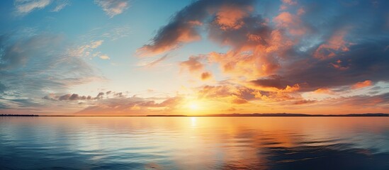 Fototapeta premium Scenic view of a sunset with dramatic clouds in the sky, perfect for a copy space image.