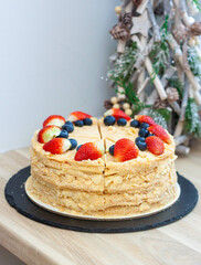 Napoleon cake decorated with fresh berries and fruits. Delicious dessert for any occasion