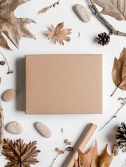 autumn leaves and brown paper box on white background
