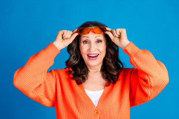 Photo portrait of attractive senior woman take off sunglass amazed dressed stylish orange clothes...