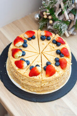 Napoleon cake decorated with fresh berries and fruits. Delicious dessert for any occasion