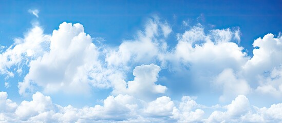 Blue sky with white clouds against a white background, ideal for copy space image.