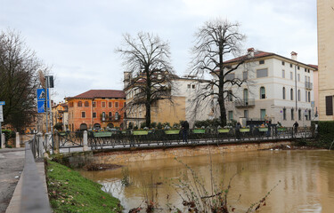 River overflowed during a city flood and the homes of the population lapped by the muddy water and FURO BRIDGE of Vicenza City