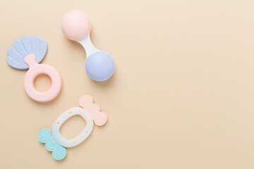 Colorful baby rattles and toys on color background, top view
