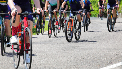 bicycles and the legs of cyclists pedaling during a cycling race