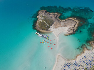 Aerial view of Nissi island and empty beach in Ayia Napa, Cyprus. Calm turquoise Mediterranean sea...