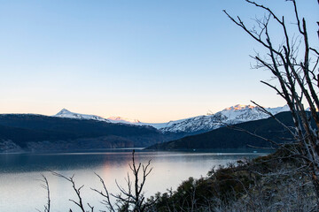Early morning panoramic view over Lago Grey lake in Torres del Paine National Park, Chile with first light of sunrise on snow covered mountains along the lake
