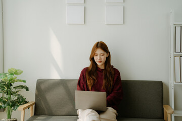 A woman is sitting on the sofa with a girlfriend's mug in her hand. She is smiling and she is...