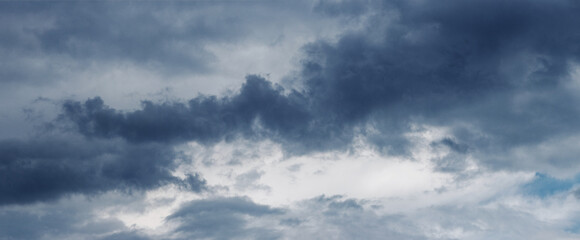 A dark blue cloud in a stormy sky