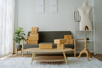 Small business owners who are just starting out, working with laptops and calculators with cardboard boxes at work, small business entrepreneurs, SME