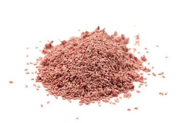 A Pile of Dried Red Raspberry Seeds Isolated on a White Background