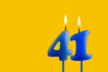 Blue candle number 41 - Birthday on yellow background