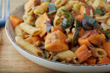 Plate of vegetarian pasta bolognese garnished with herbs.
