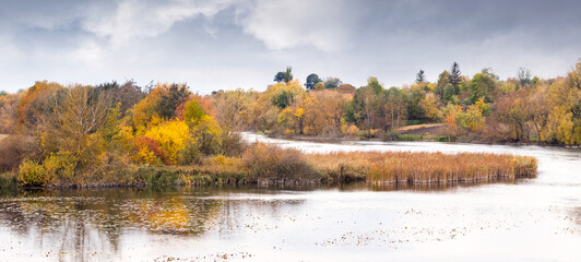 Autumn landscape with colorful trees on the banks of the river