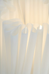 White sculptural papercraft lamp. Mid-century modern decor. Close-up photograph.