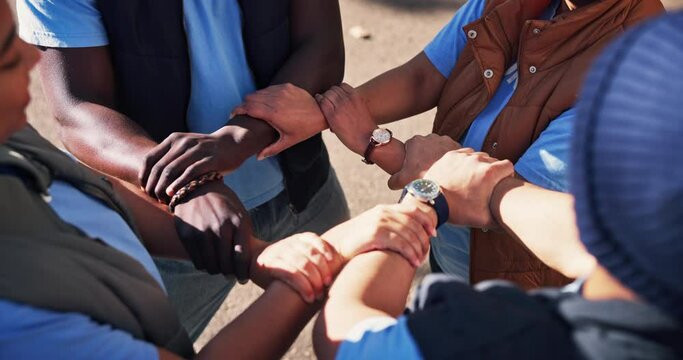 People, wrist and hands outdoor for teamwork on community service or program, collaboration and solidarity. Diversity, huddle and together to volunteer for charity or social justice and unity support