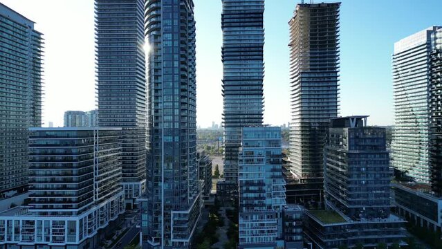 Aerial drone close up footage of highrise buildings in Humber Bay Etobicoke Toronto Canada on a sunny day with blue sky