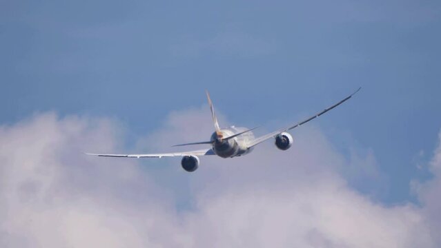 The Commercial passenger airplane flying overhead on sunny day on June  in Moscow, Russia.