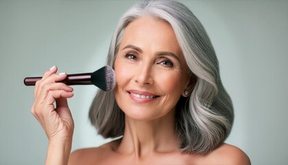 Fototapeta premium Elder woman applying powder