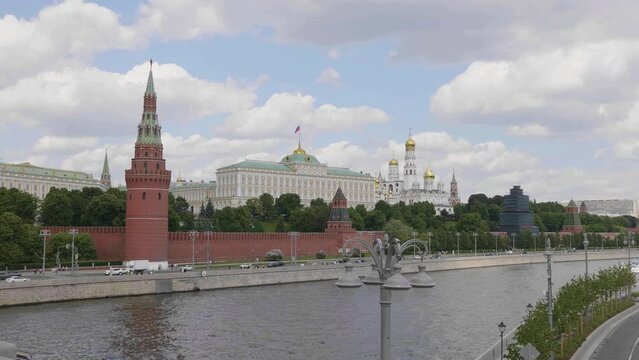 View of the Moscow Kremlin from the Moscow river. Red brick towers and Bell Tower Of Ivan The Great.