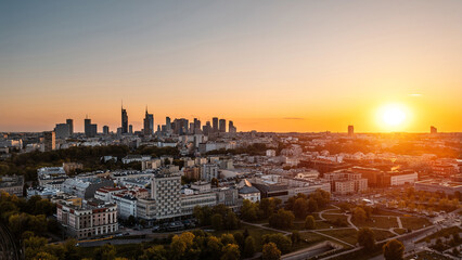 panorama of Warsaw city skyline at sunset, skyscrapers of downtown and green park, aerial top view