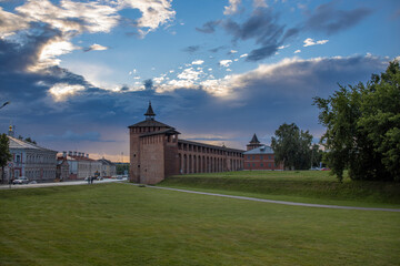 A massive structure looms atop a vibrant, verdant meadow, creating a striking contrast between...
