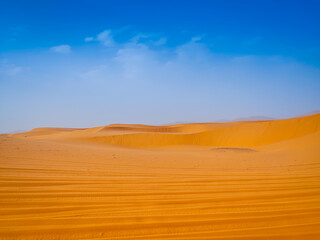 Beautiful panoramic view of sand dunes with car tracks in the Sahara desert, Merzouga, Morocco, North Africa