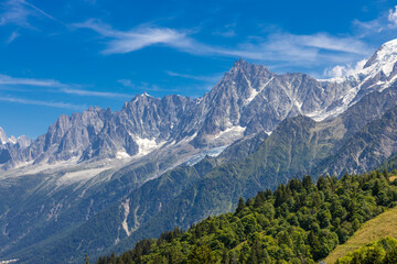 Chamonix Montblanc beautiful alpine mountain summits landscape. Alps mountains with snow and glacier above green valley of Chamonix in France. Alps beautiful scenery in summer