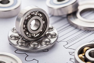 different bearings on blue print background. Part of mechanism.
