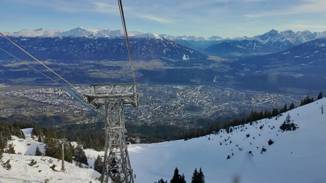 Alpine ski resort Nordkette on a sunny day. Going down with the cable car into the valley to Innsbruck, Tirol, Austria