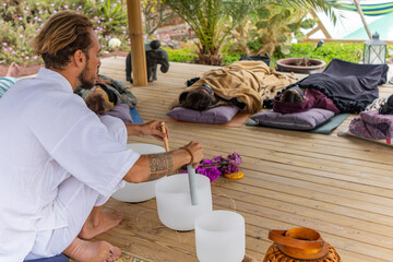 Sound therapy session with crystal bowls and relaxed participants