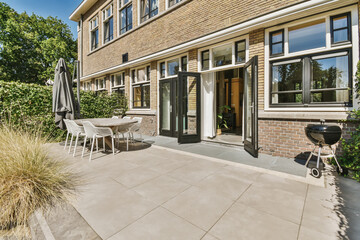 Sunny patio area with open doors and modern furniture