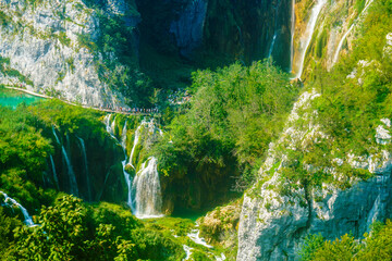 Tourists exploring the lakes and stunning landscapes in Plitvice Nature Park in Croatia